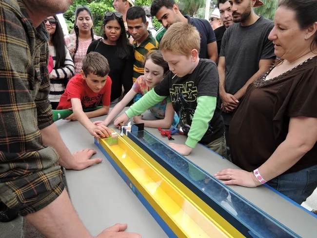 Youngsters, as well as adults, delight in watching the cockroach races. (Photo by Kathy Keatley Garvey)