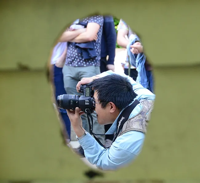 UC Davis Picnic Day offers a lot of photo opportunities. Here Alex Nguyen, an entomology graduate, focuses on the "Entomology Band" at last year's Picnic Day. The band will not be performing this year, but photographers can find plenty of other subjects. (Photo by Kathy Keatley Garvey)