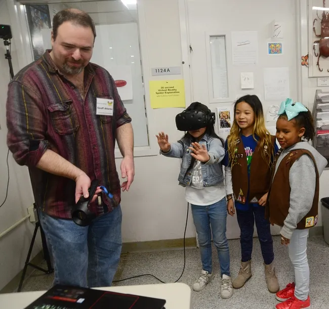 At a recent Bohart Museum of Entomology open house on spiders, medical entomologist Geoffrey Attardo demonstrated his virtual reality system. The girls, members of Brownie Girl Scout Troop 30477, Vacaville, are (from left) Jayda Navarrette, 8; Keira Yu, 8, and Kendl Macklin, 7. (Photo by Kathy Keatley Garvey)