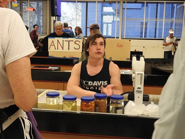 Graduate student/forensic entomologist Alex Dedmon, who studies with forensic entomologist Robert Kimsey, answers a question at the UC Davis Picnic Day. (Photo by Kathy Keatley Garvey)
