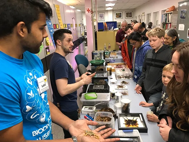 Bohart associates and entomology students Lohit Garikipati show scorpions to the crowd. (Photo by Kathy Keatley Garvey)