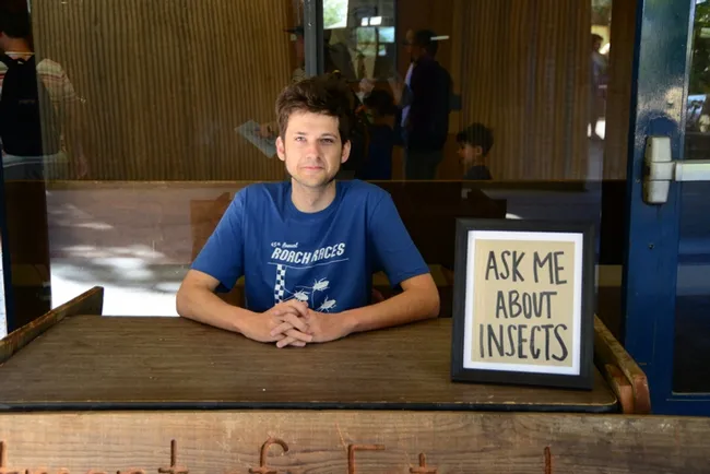 Doctoral student Zachary Griebenow of the Phil Ward lab waits for folks to ask him questions. (Photo by Kathy Keatley Garvey)