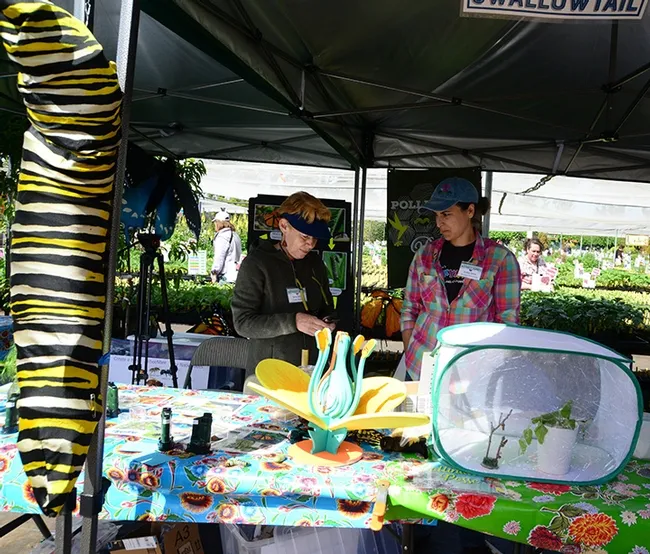 Terry Smith (left), co-founder of the Pollinator Posse, and Jackie Salas, horticulturist at Children's Fairyland, Oakland, staff the Pollinator Posse booth. (Photo by Kathy Keatley Garvey)