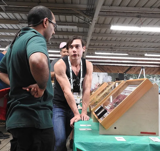 Forensic entomologist Alex Dedmon, a doctoral student at UC Davis, responds to a question from a fairgoer Saturday at the Dixon May Fair. (Photo by Kathy Keatley Garvey)