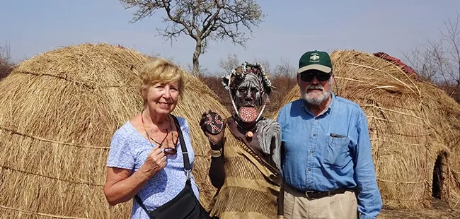 James R. Carey, UC Davis distinguished professor of entomology and his wife, Patty, with a Mursi woman (Ethiopia) showing her lip plate. Also known as a lip disc, it is a status symbol among the Mursi women.