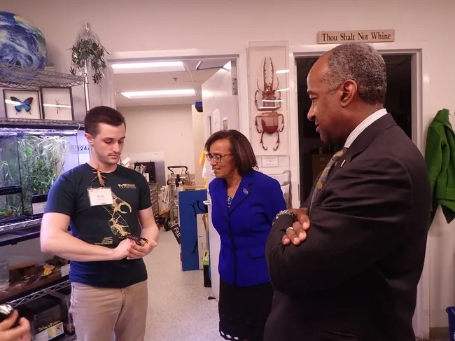 Bohart associate and entomology student Wade Spencer (left) shows Chancellor Gary May and Dean Helene Dillard a stick insect from the Bohart Museum of Entomology's petting zoo. (Photo by Kathy Keatley Garvey)