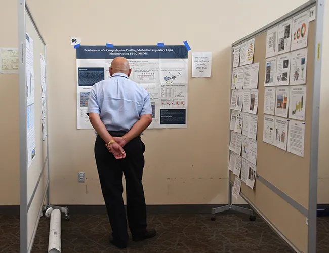 Research posters at the Bruce Hammock Alumni Lab Reunion were mostly scientific--except for several fun ones, including a water balloon battle poster. (Photo by Kathy Keatley Garvey)