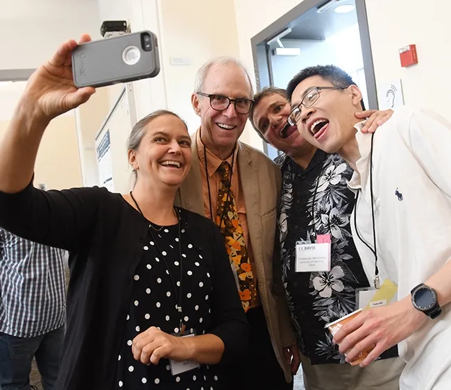 Fun at the lab reunion: Karen Wagner, Hammock lab alumnus, takes a selfie with Jim Sanborn, retired from UC Davis; researcher Christophe Morisseau of the Hammock lab, and Kin Sing Stephen Lee of Michigan State University, an alumnus of the Hammock lab. (Photo by Kathy Keatley Garvey)