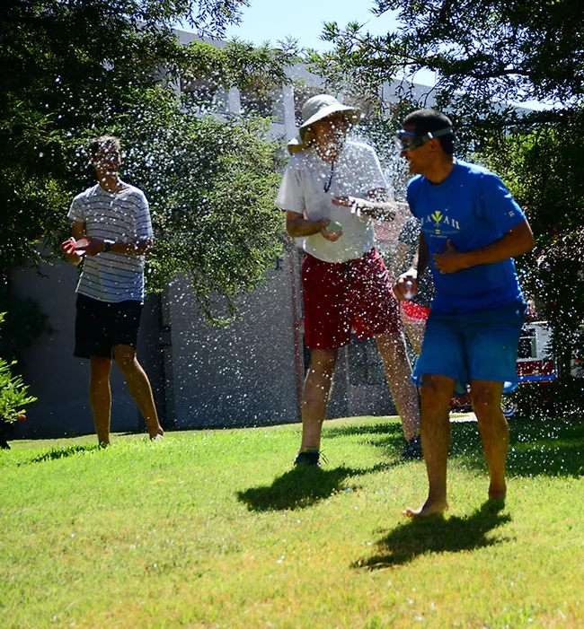 Splash! It was an international soakfest at the Bruce Hammock Lab Water Balloon Battle, with eight countries represented. That's Hammock in the center getting sprayed. (Photo by Kathy Keatley Garvey)