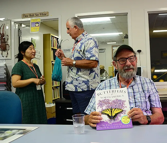 Professor Paul Opler (foreground) is the author of "Butterflies of North America." In back, Jeff Smith, curator of the Lepidoptera collection at the Bohart Museum, chats with Sangmi Lee of Arizona State University. (Photo by Kathy Keatley Garvey)