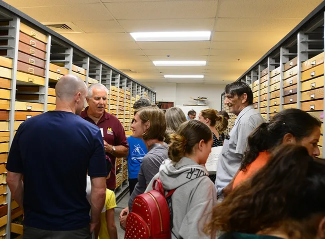Entomologist Jeff Smith (second from left), who curates the Lepidoptera section of the museum, talks to visitors at the "Moth Night" open house. (Photo by Kathy Keatley Garvey)
