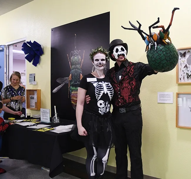 Charlotte Herbert Alberts and husband George Alberts with the parasitoid pinata they created. (Photo by Kathy Keatley Garvey)