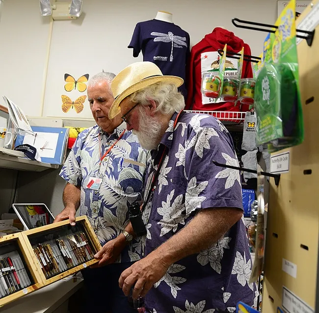 Entomologist Jeff Smith (back), who curates the Lepidoptera section at the Bohart Museum, handmade these pens, available in the gift shop. With him is Robert Michael Pyle of Grays River, Wash., founder of the Xerces Society for Invertebrate Conservation. (Photo by Kathy Keatley Garvey)