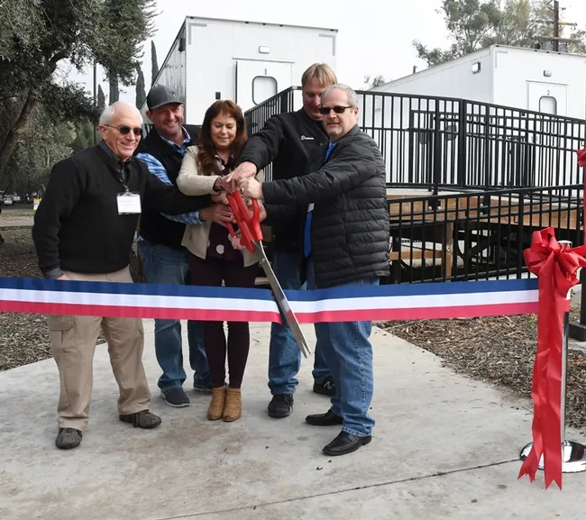 Ready to cut the ribbon (from left) are almond pollination consultant Robert Curtis of Carmichael, retired director of agricultural affairs, Almond Board of California; Brad Pankratz of Can-Am Apiaries, Orland; Jackie Parks-Burris of Jackie Park-Burris Queen Bees, Palo Cedro and a past president of California State Beekeepers' Association; Darren Cox, Logan, Utah, past president of American Honey Producers; and Kelvin Adee of Bruce, S.D., president of American Honey Producers.