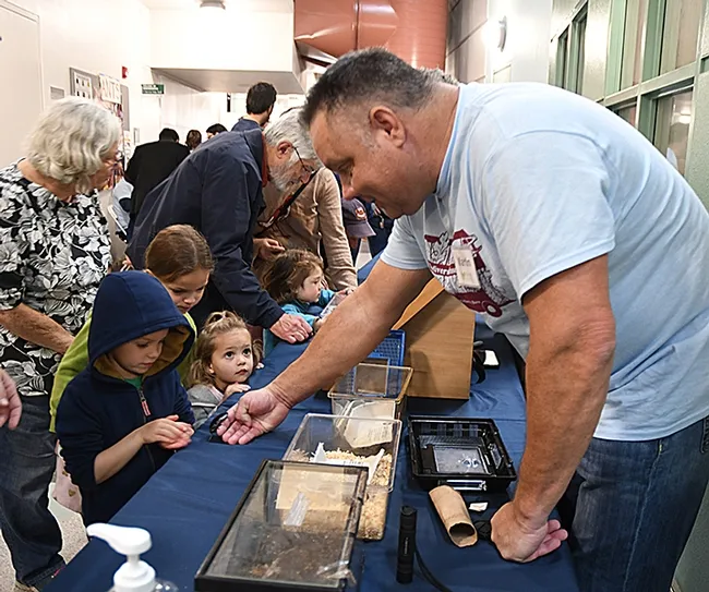 Martin Hauser, senior insect biosystematist with the Plant Pest Daignostics Branch, California Department of Food and Agriculture, shows Madagascar hissing cockroaches to visitors. (Photo by Kathy Keatley Garvey)
