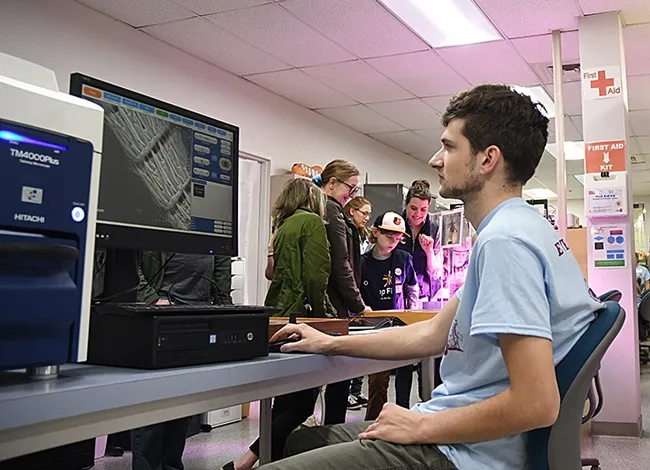 Ant specialist Zach Griebenow, a doctoral student in the Phil Ward lab, introduced visitors to magnified insects. (Photo by Kathy Keatley Garvey)