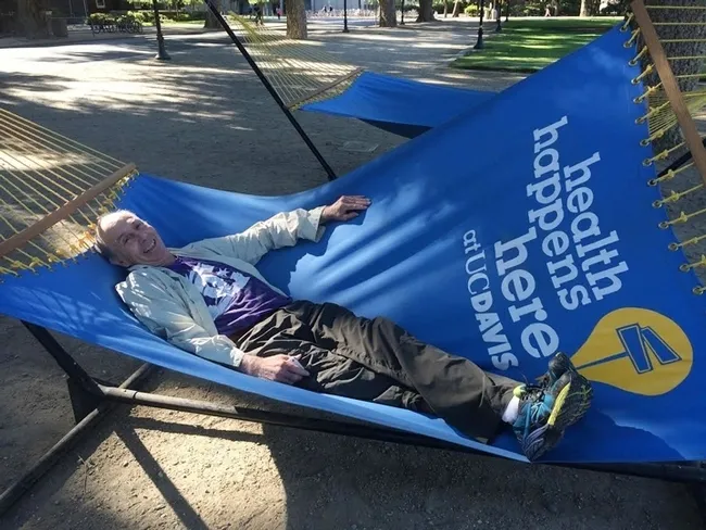 UC Davis distinguished professor Bruce Hammock "rests" in a hammock on the UC Davis campus. The occasion: the Hammock lab scientists were walking across campus (before the coronoavirus pandemic precautions). (Photo by Cindy McReynolds)