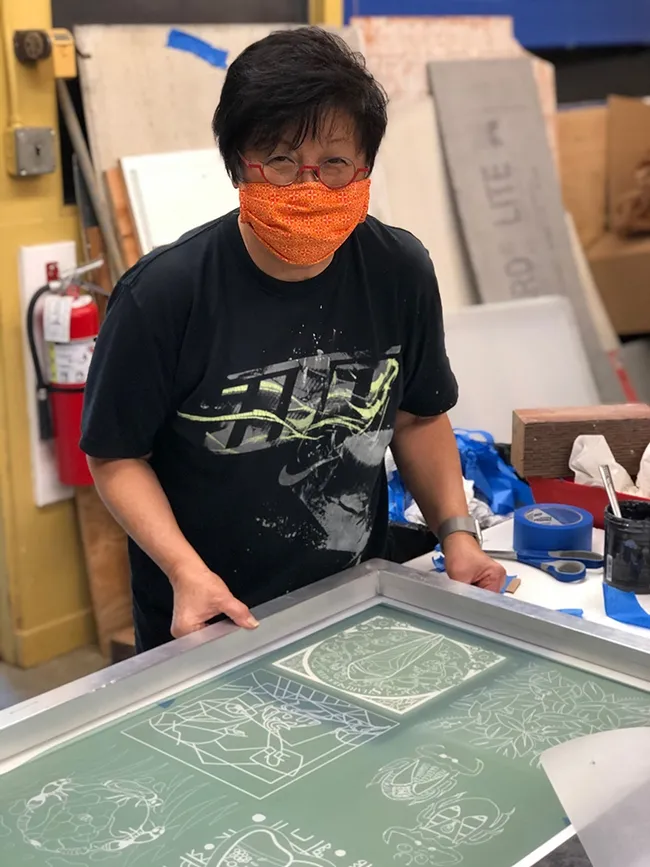 Designer-lecturer Gale Okumura of the UC Davis Department of Design engaged in printing