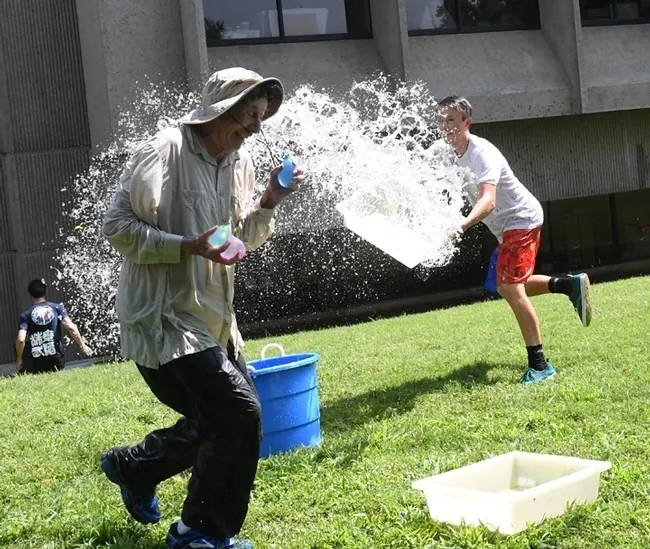 Gotcha! UC Davis distinguished professor Bruce Hammock gets doused at a water balloon battle. (Photo by Kathy Keatley Garvey)