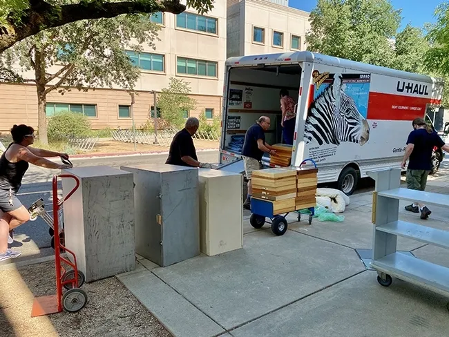 Bohart Museum director Lynn Kimsey (inside truck) and husband UC Davis forensic entomologist Bob Kimsey unload the U-Haul truck. At right is Bohart research associate Brennen Dyer. Also helping are Kimsey friends, Mike Whitney (retired Placer County sheriff) and his wife, Becky. (Photo by Steve Heydon)