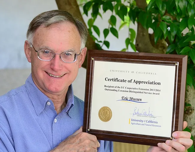 Eric Mussen with the UC Cooperative Extension 2013/2014 Outstanding Extension Distinguished Service Award. (Photo by Kathy Keatley Garvey)