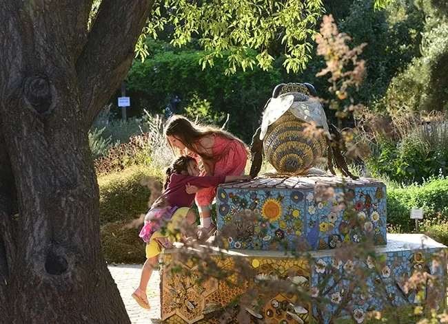 Schoolchildren love to explore "Miss Bee Haven," the sculpture that anchors the UC Davis Bee Haven.(Photo by Kathy Keatley Garvey)