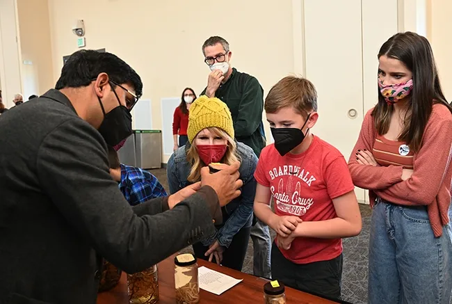 Nematologist Shahid Siddique, assistant professor, UC Davis Department of Entomology and Nematology, shows nematodes to curious visitors. (Photo by Kathy Keatley Garvey)