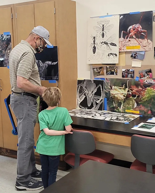Ant posters from the Phil Ward lab drew the attention of these visitors. (Photo by Danielle Rutkowski)