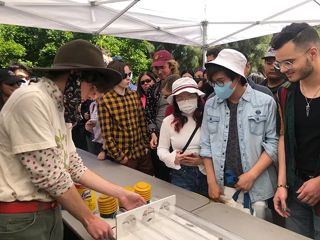 Ian Clark (foreground) works the crowd and the roaches. (Photo by Kathy Keatley Garvey)