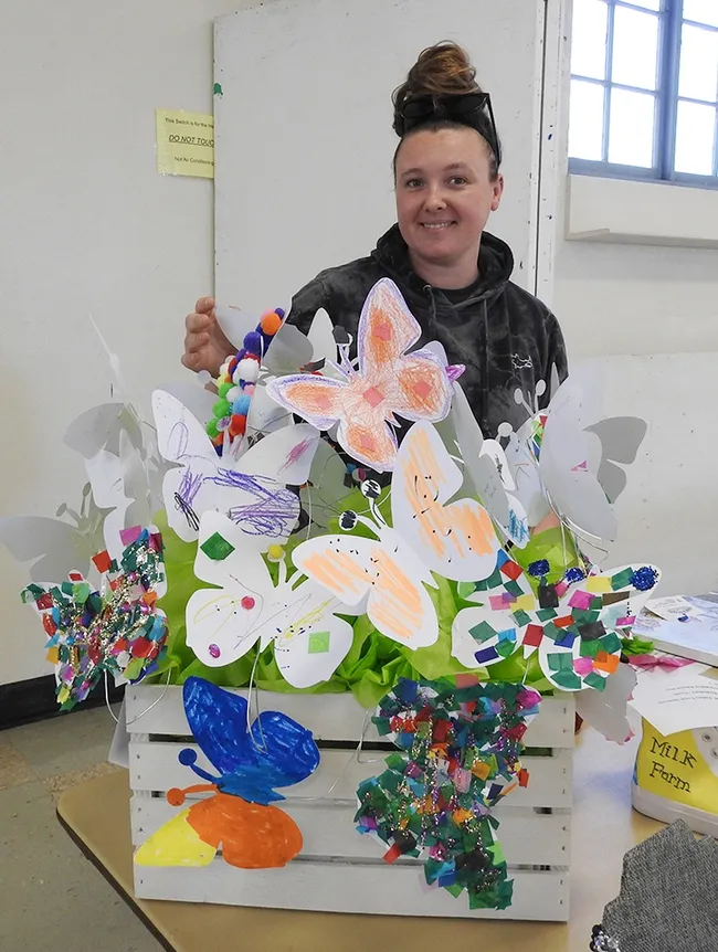 Leta Myers admires this entry in the Dixon May Fair. It is by a Tremont Elementary School classroom and is on display in the Youth Building (Denverton Hall). Myers, a marine biologist, and her husband, in the military, just returned from Japan and their next move is to Washington state. (Photo by Kathy Keatley Garvey)