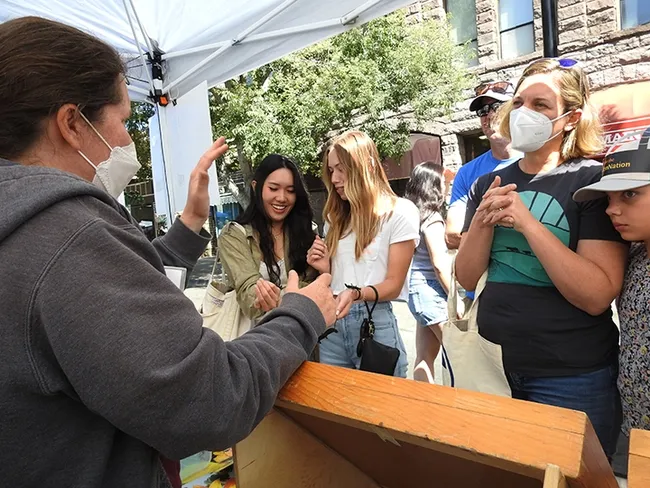 Tabatha Yang, the Bohart Museum of Entomology's education and outreach coordinator, "talks bugs" with visitors at the California Honey Festival. (Photo by Kathy Keatley Garvey)