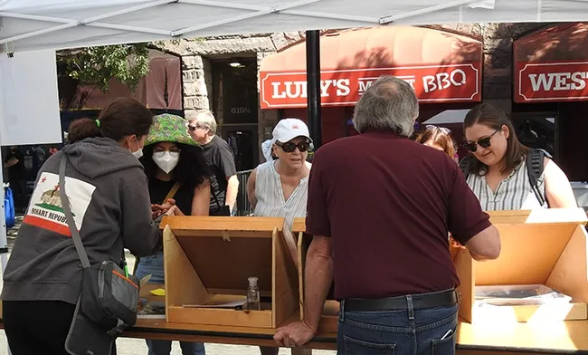 Tabatha Yang, education and outreach coordinator and senior museum scientist Steve Heydon of the Bohart Museum of Entomology greet visitors at the California Honey Festival. (Photo by Kathy Keatley Garvey)
