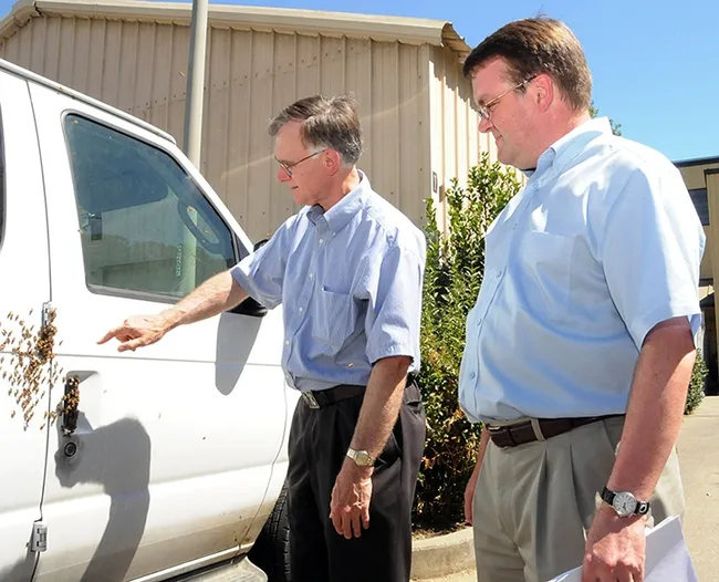 In this image, taken Aug. 1, 2008, Extension apiculturist Eric Mussen (left) talks to vanpool driver Keir Reavie, head of the Biological and Agriculture Sciences Department at Shields Library, about the bees that "hitched" a ride on a commuter van traveling from El Cerrito to the UC Davis campus. (Photo by Kathy Keatley Garvey)