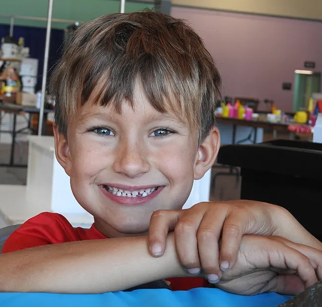 When you first meet 6-year-old Brandon DeGroot, he'll tell you "I love spiders and snakes" and he'll flash a big smile. (Photo by Kathy Keatley Garvey)