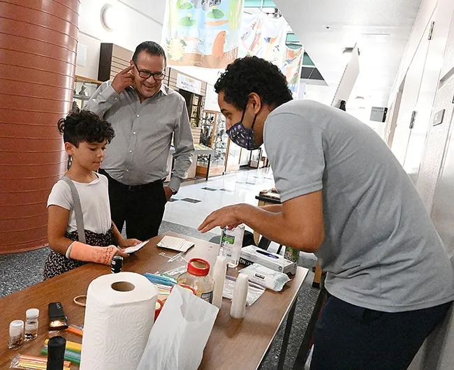 Marta Erismann, 8, of Sacramento arrives with her father, Fernando Erismann. (Photo by Kathy Keatley Garvey)