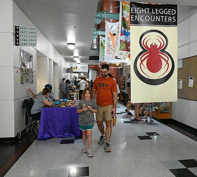 There were smiles all around at the Bohart Museum/AAS Open house in the Academic Surge Building. A banner, "Eight-Legged Encounters," drew them in. (Photo by Kathy Keatley Garvey)