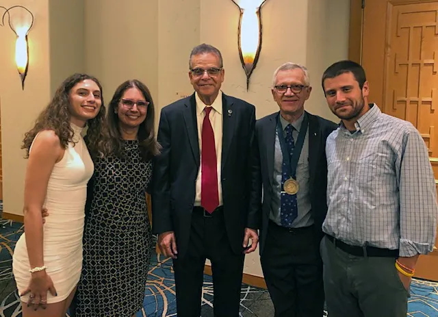 NAI president Paul Sanberg (center) with Walter Leal and his family. Pictured are his wife Beatriz; daughter Helena; and son Gabriel. Both siblings authored papers while in the Leal lab. Gabriel is now a law office clerk and Helena is an UX designer with Amazon. Not pictured is son Gabriel. (Courtesy Photo)