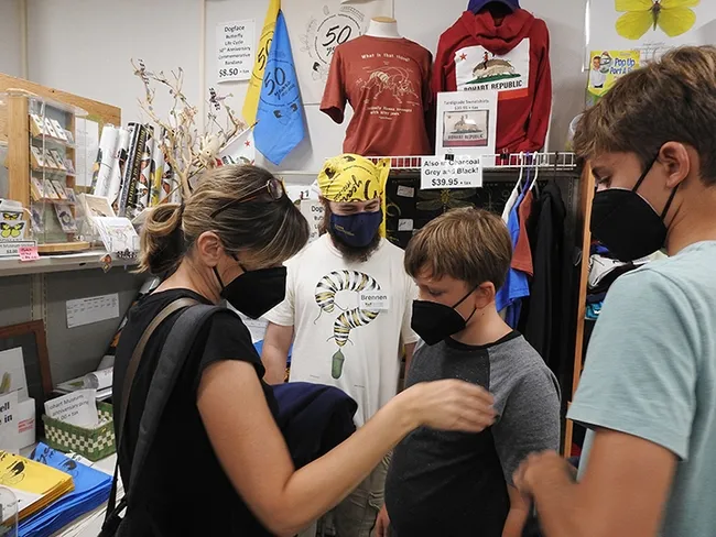 Bohart Museum lab assistant Brennen Dyer (in back, center) staffs the Bohart Museum gift shop. (Photo by Kathy Keatley Garvey)