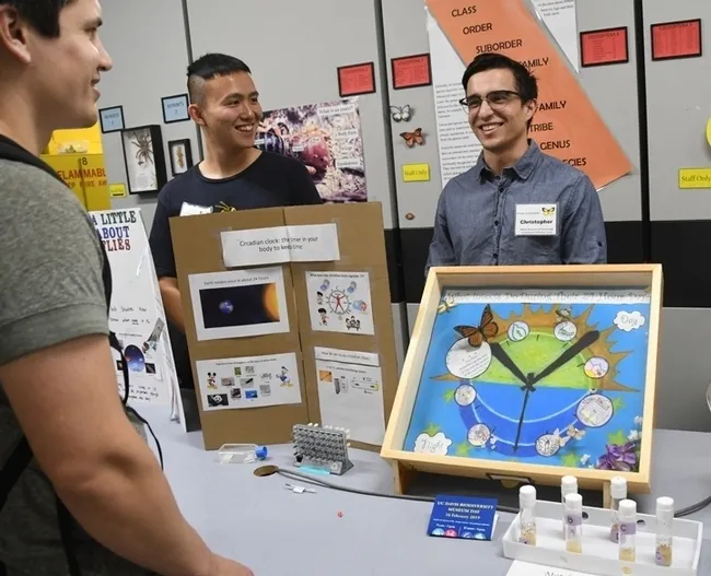 Molecular geneticist Yao Cai (left) presents a program at a 2020 Bohart Museum of Entomology open house. With him is undergraduate student Christopher Ocoa. (Photo by Kathy Keatley Garvey)