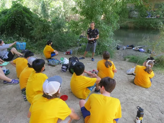 UC Davis student Christofer Brown presents a program on dragonflies to middle schoolers enrolled in the UC Davis Bio Boot Camp, held in the summer of 2022. This image was taken by Putah Creek. (Tabatha Yang Photo)