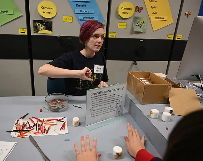 High school student Kate Phillips of the Da Vinci Charter Academy leads the dragonfly candle project. (Photo by Kathy Keatley Garvey)