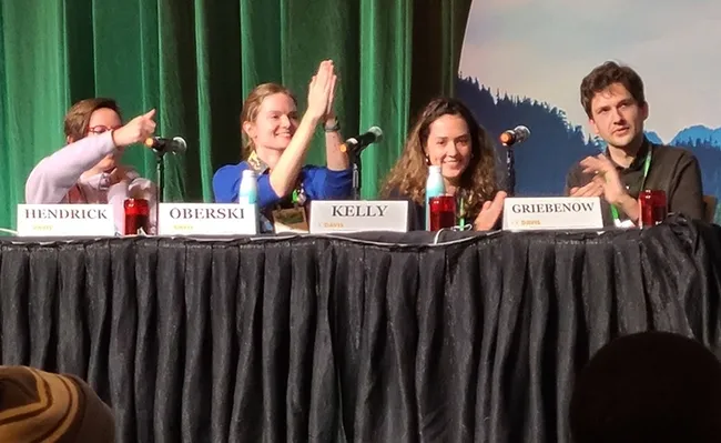 Victory! Gamesmaster Alix Whitener announced the championship team, the crowd cheered and the champions, the UC Davis Entomology Games Team, responded. (Photo by Geoffrey Attardo, UC Davis faculty)