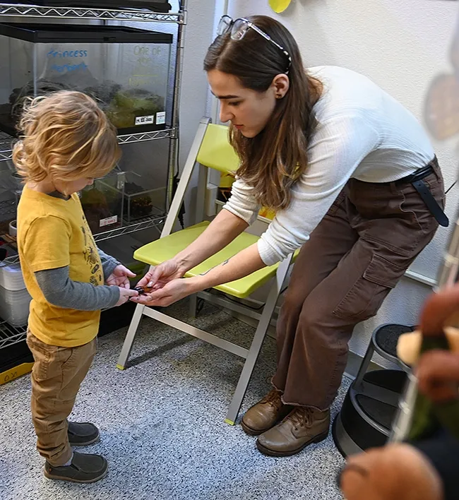 Bohart Museum research associate and "zookeeper" Brittany Kohler, a prospective graduate student, shows Teddy Marlatte a Madagascar hissing cockroach. (Photo by Kathy Keatley Garvey)