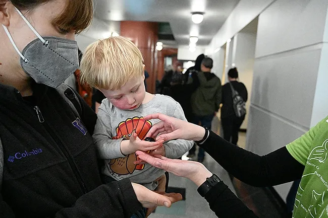 Connected! A Madagascar hissing cockroach and Finn Jensen meet. (Photo by Kathy Keatley Garvey)