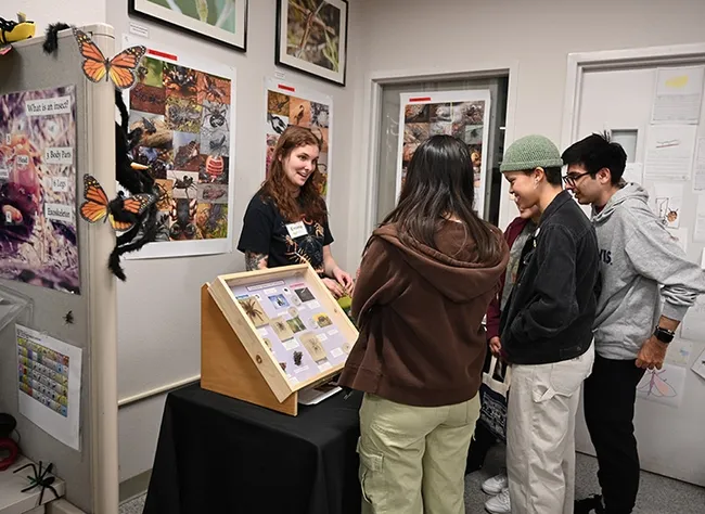 UC Davis doctoral student Emma Jochim answers questions at her station. (Photo by Kathy Keatley Garvey)