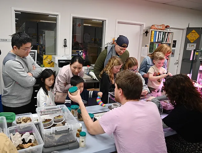 Doctoral candidate Xavier Zahnle greets visitors at the Bohart Museum open house. More than 350 attended. (Photo by Kathy Keatley Garvey)