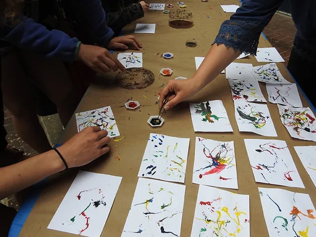 Hands reach for more maggots. (Photo by Kathy Keatley Garvey)