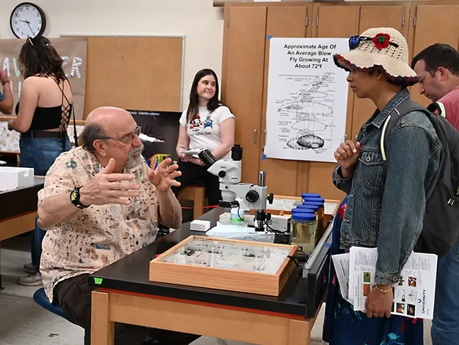 UC Davis forensic entomologist Robert Kimsey discusses his research with UC Davis neuroscience major Anandita De. In back is UC Davis postdoctoral scholar Elizabeth Cinto Mejia, newly arrived in the lab of urban landscape entomologist Emily Meineke, Department of Entomology and Nematology. (Photo by Kathy Keatley Garvey)