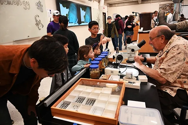 Visitors of all ages headed over to the Dr. Death booth, staffed by forensic entomologist Robert Kimsey. (Photo by Kathy Keatley Garvey)