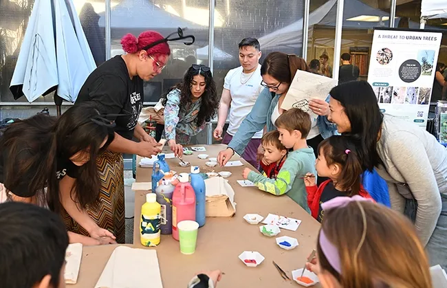 UC Davis doctoral student Iris Quayle of the Jason Bond lab supervises the Maggot Art project, as young artists dip maggots into water-based, non-toxic paint. (Photo by Kathy Keatley Garvey)